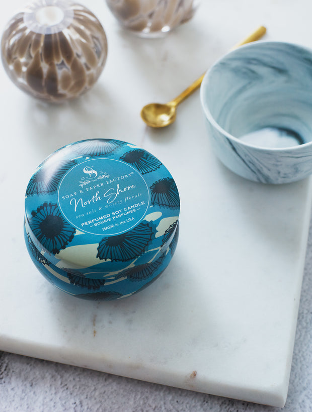 North Shore features deeply layered notes of sea salt & lush, watery florals. This 3 oz tin soy candle burns clean for up to 18 hours. Perfect for travel! 